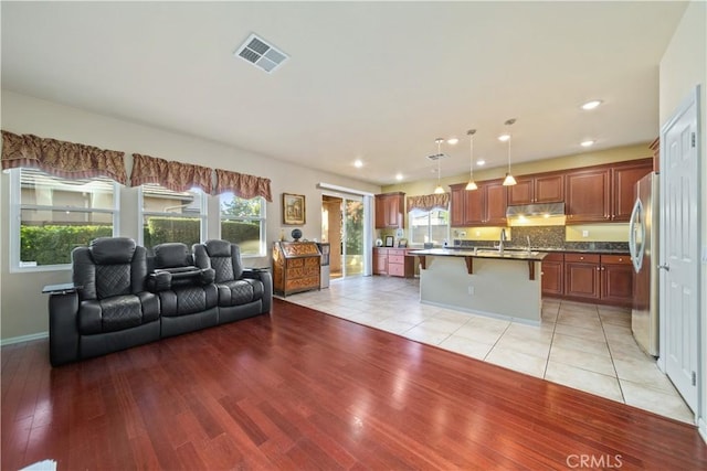 living room with light hardwood / wood-style floors and sink