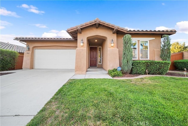 mediterranean / spanish-style house with a front yard and a garage