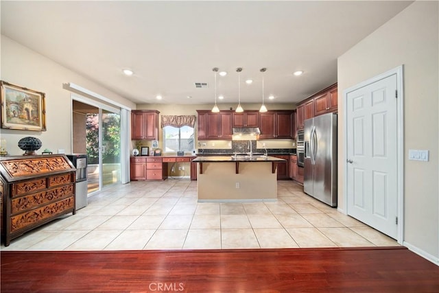 kitchen with stainless steel fridge with ice dispenser, light tile patterned floors, pendant lighting, and a center island with sink