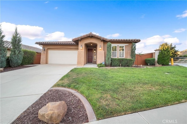 mediterranean / spanish-style house featuring a front yard and a garage