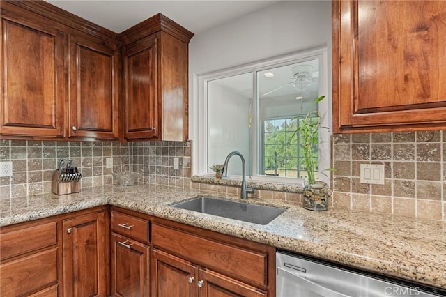11319 Choctaw Dr, Bakersfield, CA 93308 - kitchen featuring stainless steel dishwasher, light stone countertops, decorative backsplash, and brown cabinets