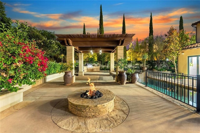 patio terrace at dusk with an outdoor fire pit