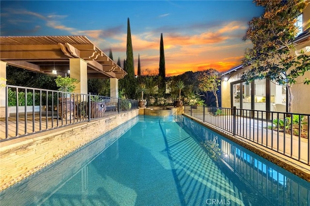 view of pool at dusk