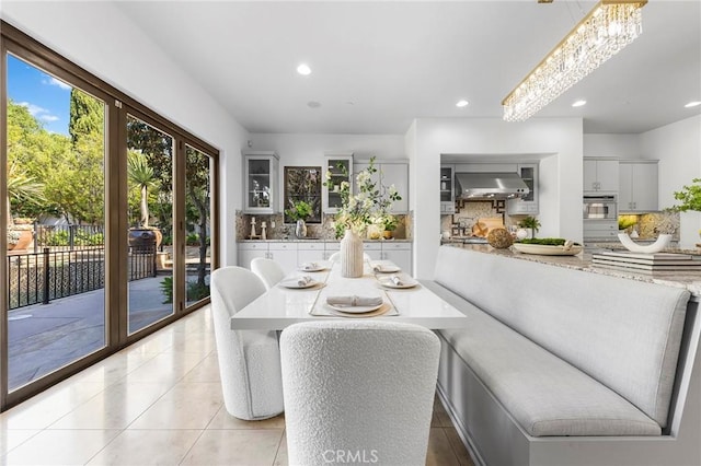 dining space with light tile patterned floors and sink