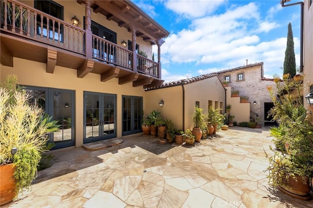 view of patio / terrace featuring a balcony and french doors