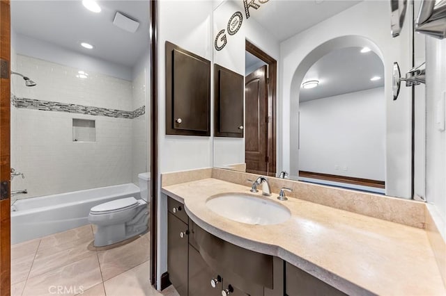 full bathroom featuring tile patterned flooring, vanity, toilet, and tiled shower / bath