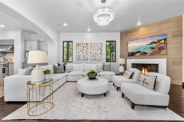 living room featuring a chandelier and dark hardwood / wood-style floors