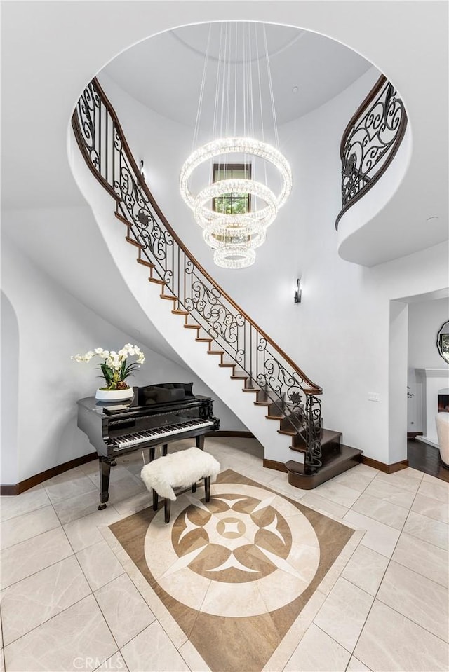 staircase with a chandelier, a high ceiling, and tile patterned flooring