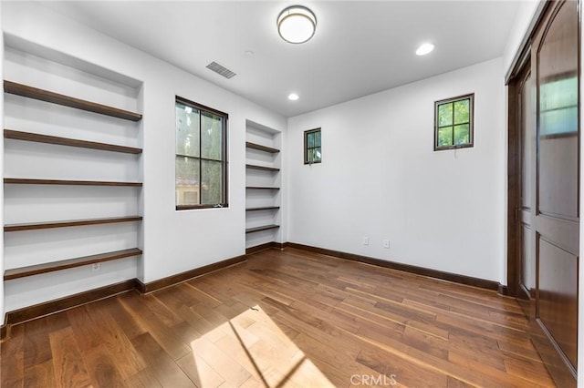 unfurnished bedroom with dark wood-type flooring