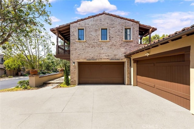 view of front of home with a balcony and a garage