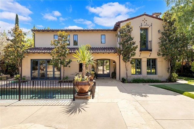 mediterranean / spanish home with a patio area