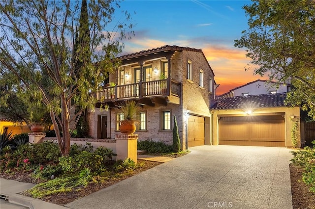 mediterranean / spanish-style home with a balcony and a garage