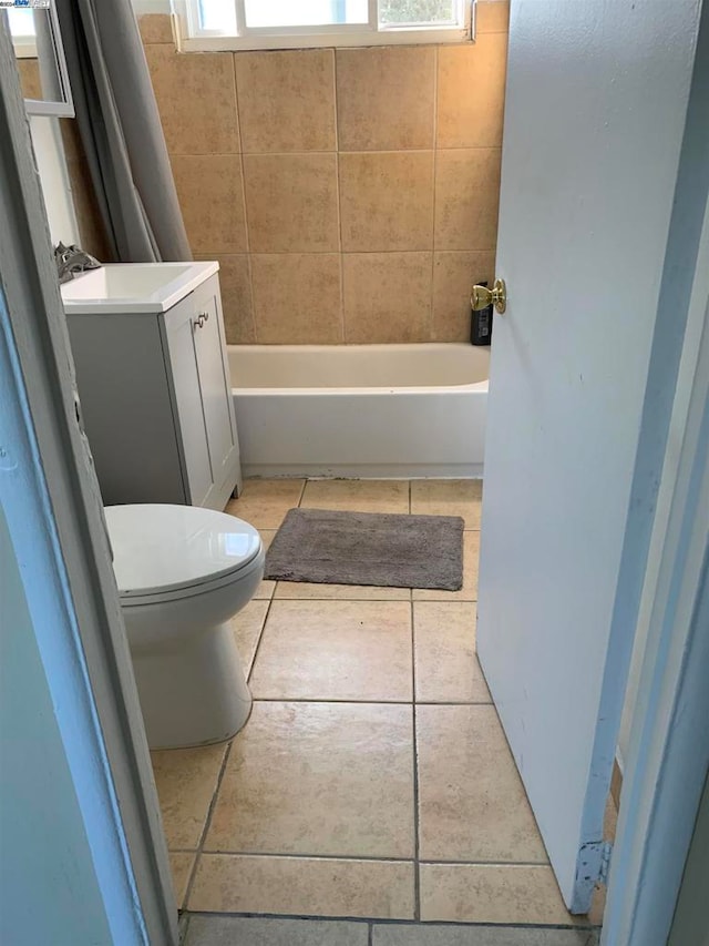 full bathroom featuring vanity, toilet, tile patterned flooring, and shower / tub combo with curtain