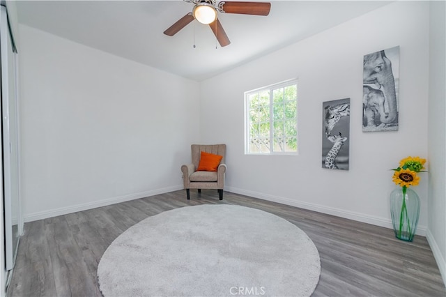 sitting room with hardwood / wood-style flooring and ceiling fan