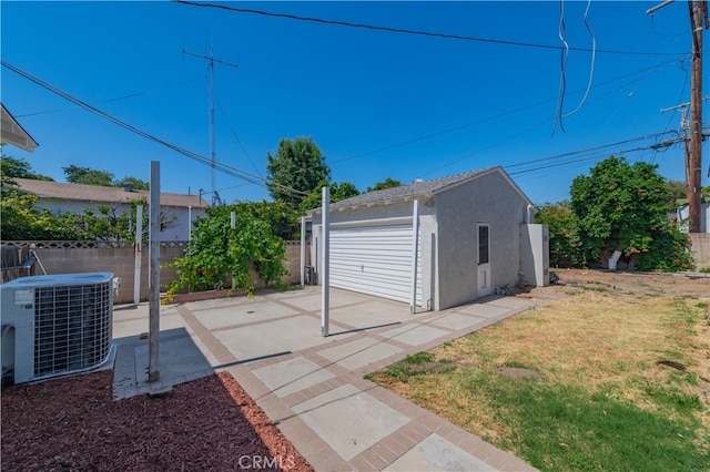 view of outdoor structure with a yard and central AC