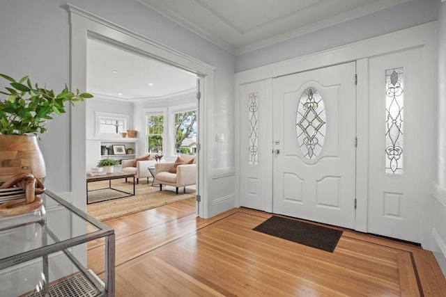 foyer featuring ornamental molding and wood-type flooring