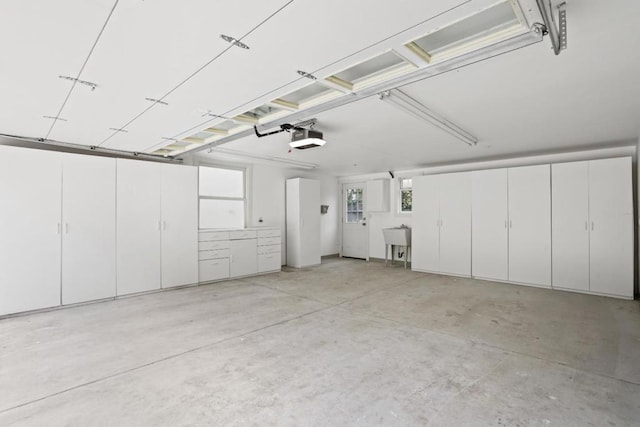 garage featuring sink and a garage door opener