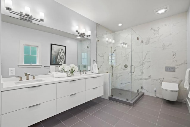 bathroom featuring tile patterned flooring, vanity, toilet, and walk in shower