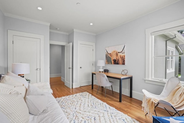 office space with crown molding and light wood-type flooring