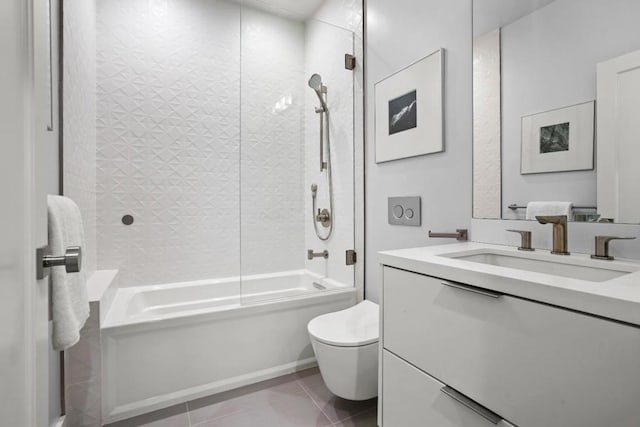 full bathroom featuring tile patterned floors, vanity, toilet, and tiled shower / bath combo