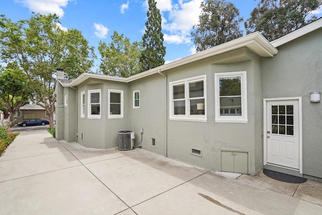 view of home's exterior with a patio and central AC unit