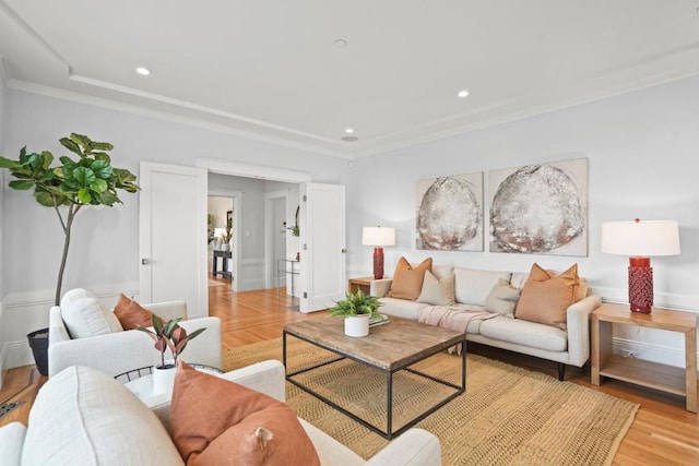 living room featuring ornamental molding and light hardwood / wood-style flooring