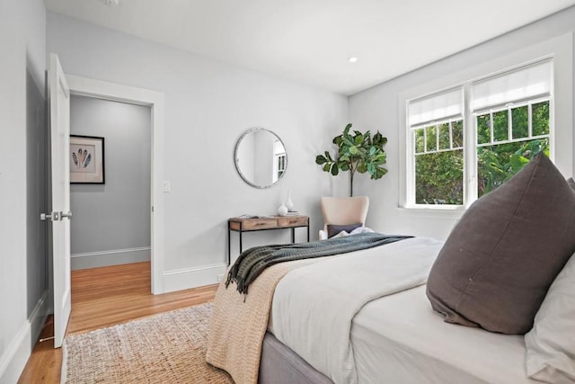 bedroom with hardwood / wood-style floors