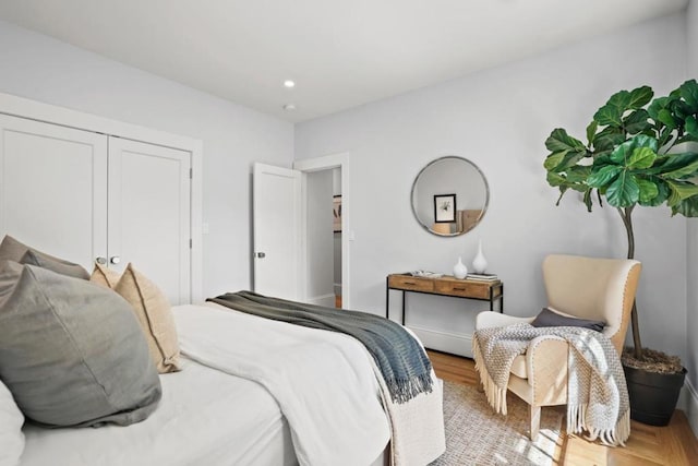 bedroom featuring hardwood / wood-style floors and a closet