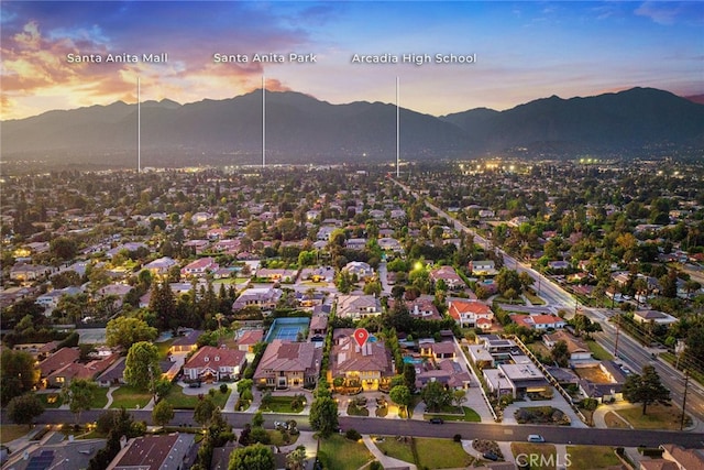 aerial view at dusk featuring a mountain view