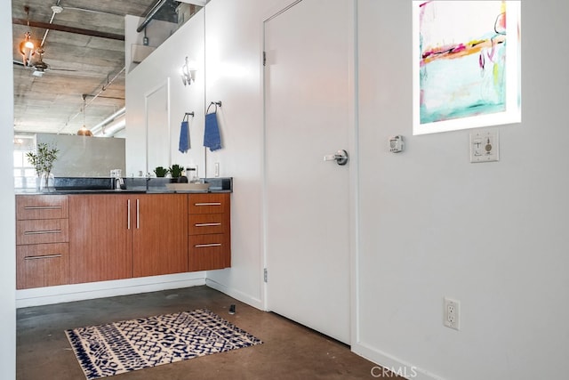 bathroom with a wealth of natural light, vanity, and concrete floors