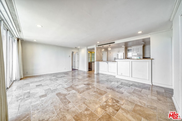 unfurnished living room featuring crown molding