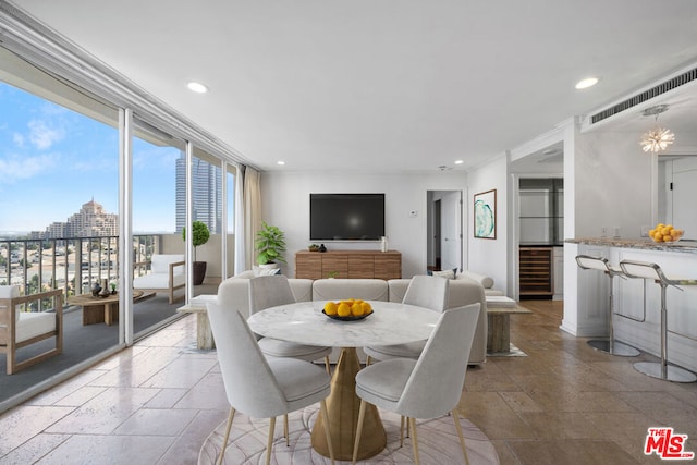 dining area with ornamental molding and wine cooler