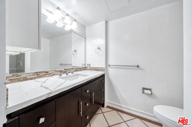 bathroom with decorative backsplash, tile patterned flooring, vanity, and toilet