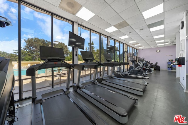 workout area featuring a paneled ceiling and plenty of natural light