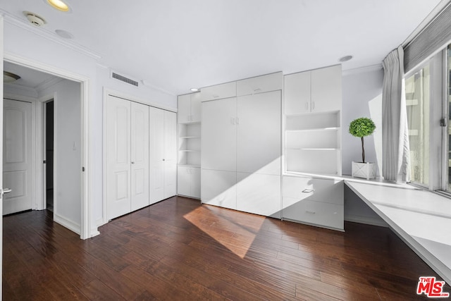 interior space featuring hardwood / wood-style floors and crown molding