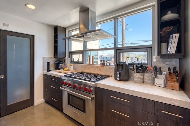 kitchen featuring decorative backsplash, designer range, extractor fan, and dark brown cabinets