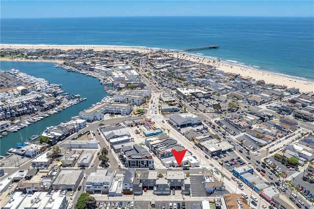 drone / aerial view with a water view and a view of the beach