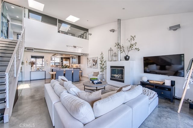 living room featuring a skylight and concrete floors