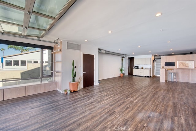 unfurnished living room with dark hardwood / wood-style floors