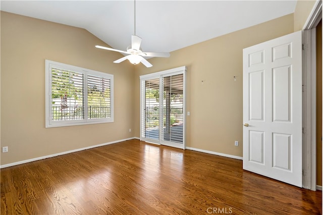 unfurnished room featuring ceiling fan, dark hardwood / wood-style floors, and vaulted ceiling