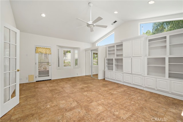 unfurnished living room with a healthy amount of sunlight, ceiling fan, and high vaulted ceiling