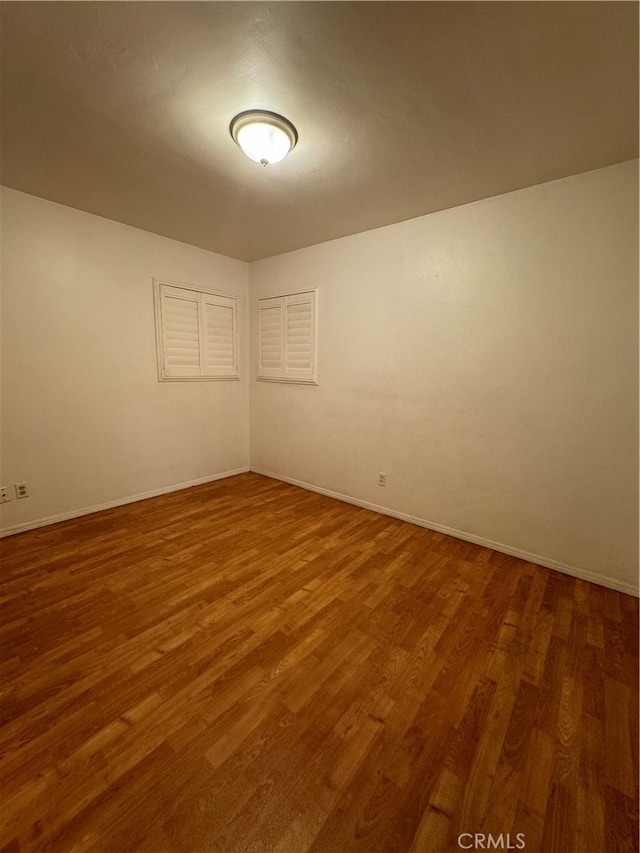 empty room with dark wood-type flooring