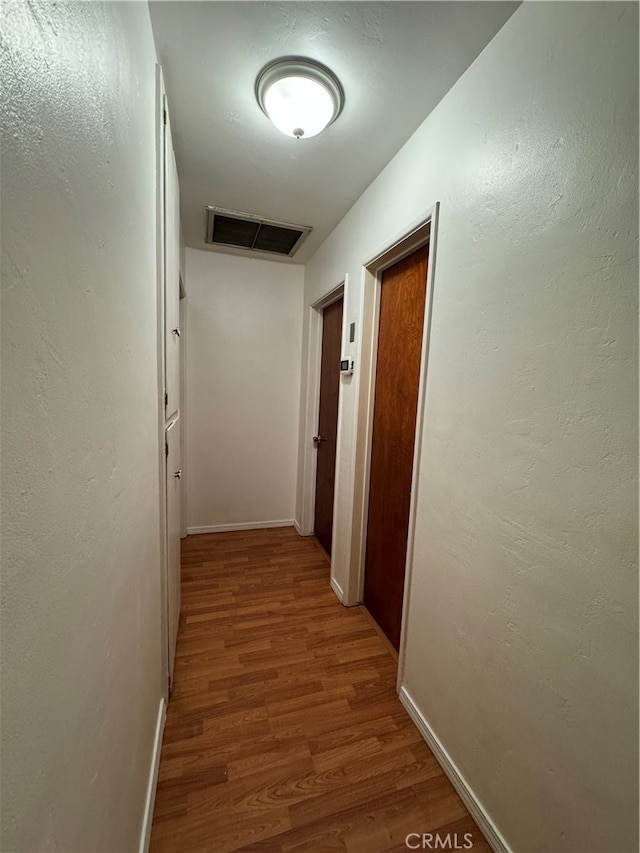 corridor featuring hardwood / wood-style flooring