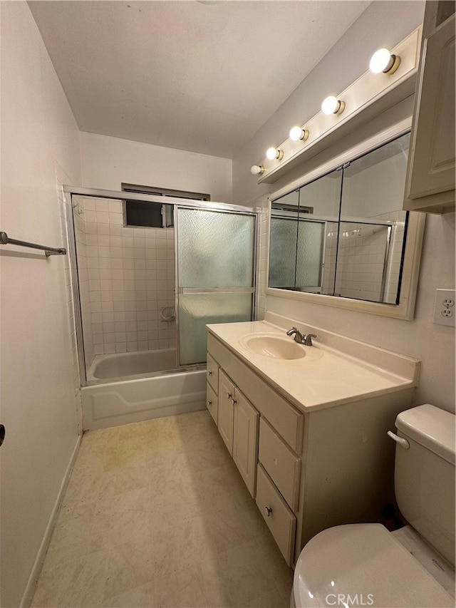 full bathroom with bath / shower combo with glass door, vanity, and toilet