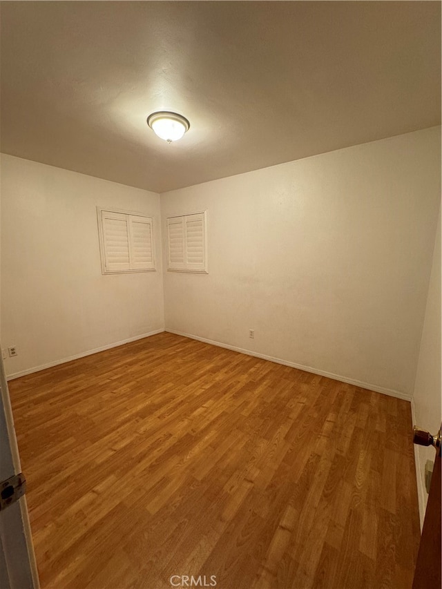 empty room featuring hardwood / wood-style flooring