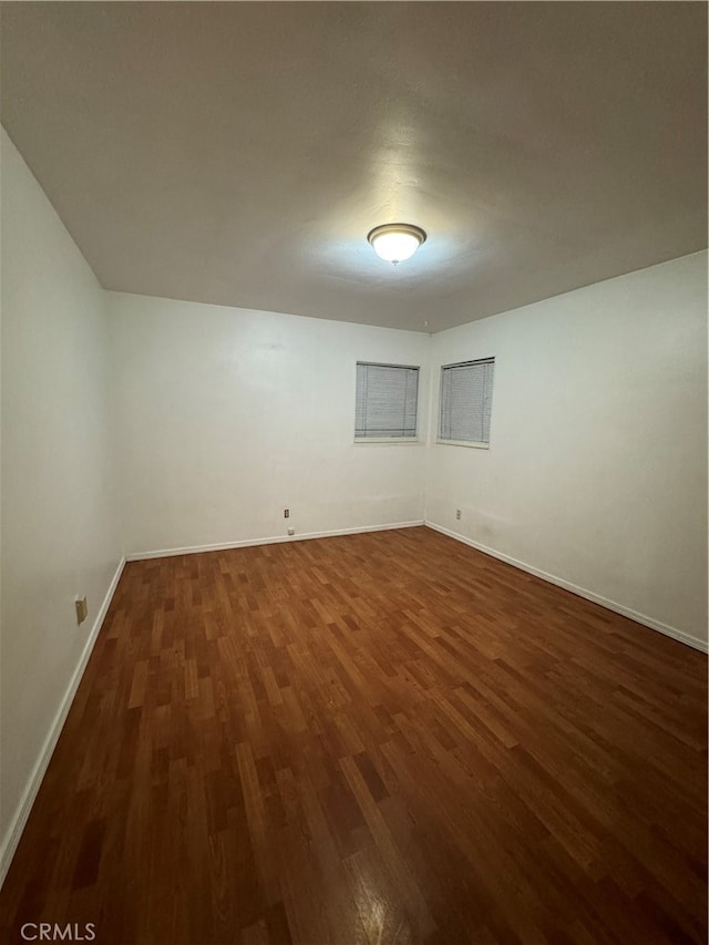 basement featuring dark hardwood / wood-style flooring