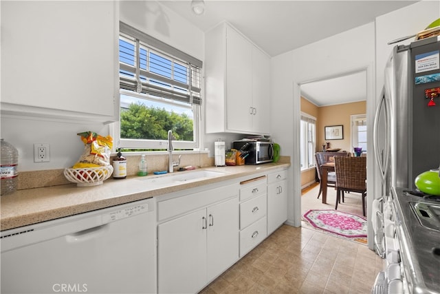 kitchen with white cabinetry, appliances with stainless steel finishes, and sink