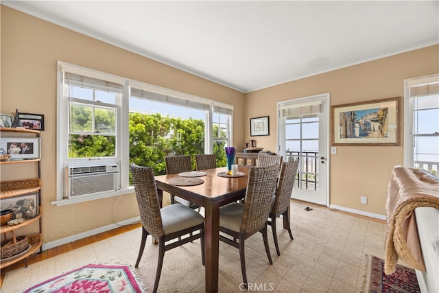 dining space with light hardwood / wood-style flooring, cooling unit, and crown molding