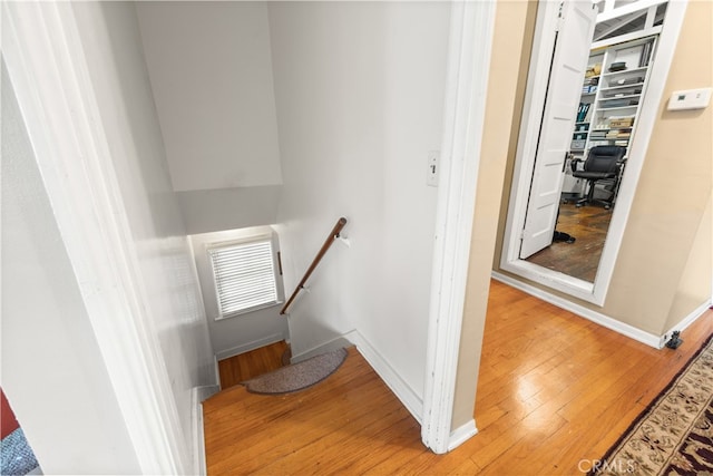 stairs featuring hardwood / wood-style floors