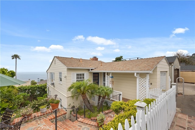 view of front of property with a water view and a garage